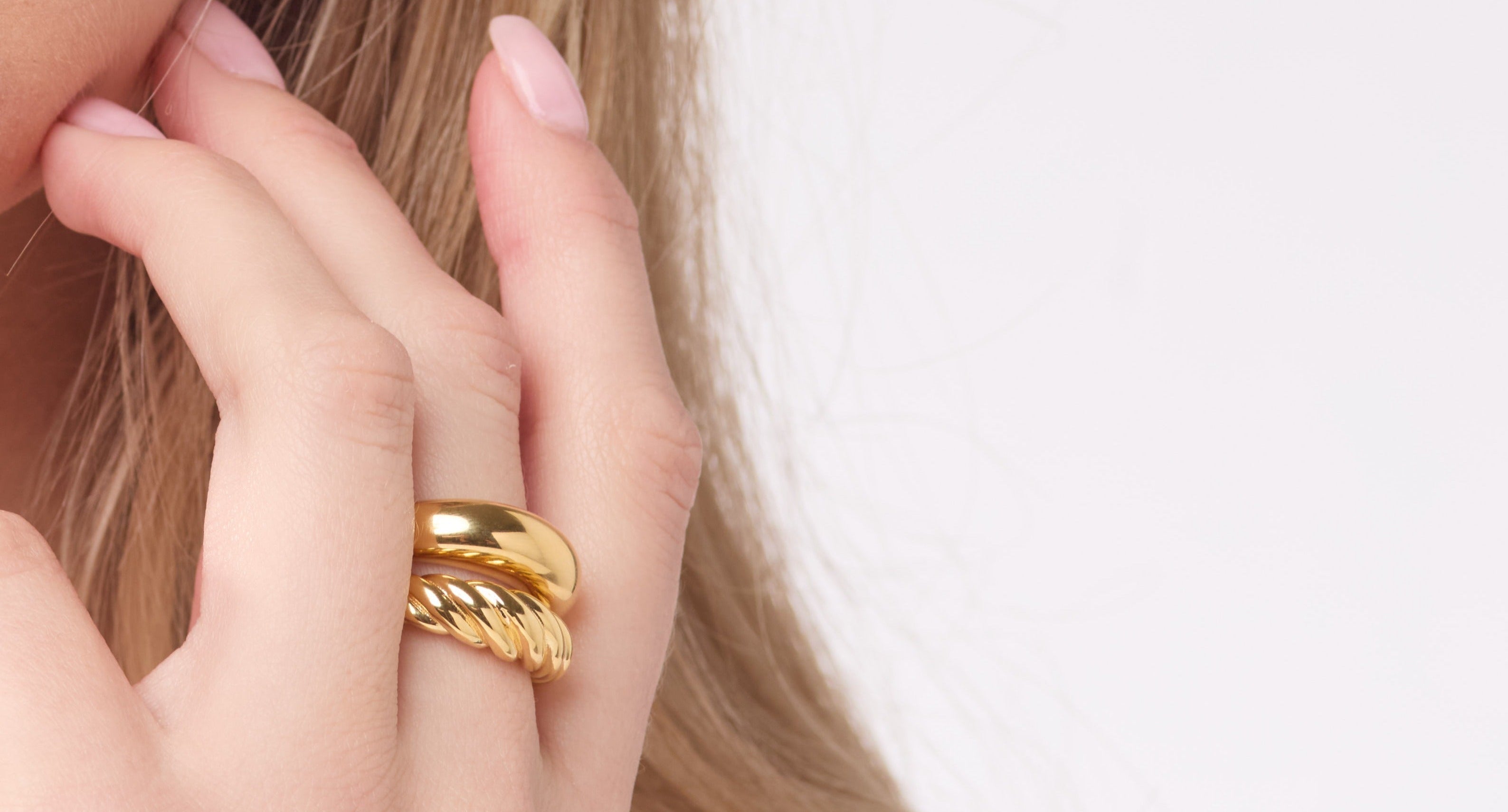 Gold ring on a finger with a blurred background