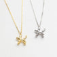 Gold and silver balloon dog pendants on white backgrounds