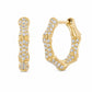 A pair of gold hoop earrings designed to look like bamboo stalks, paved with clear round-cut stones, shown on a plain white background.