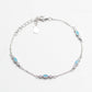Silver bracelet with blue gemstones on a white background