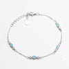 Silver bracelet with blue gemstones on a white background