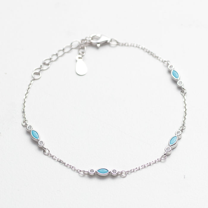 Silver bracelet with blue gemstones on a white background