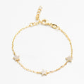Gold bracelet with star-shaped charms on a white background