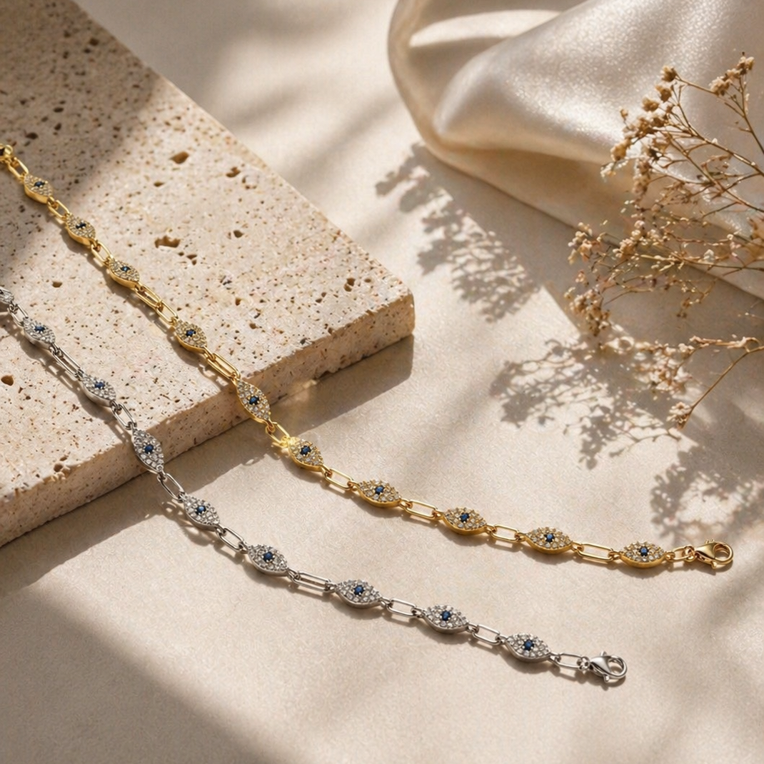Gold chain necklace with small stones on a beige fabric background