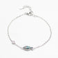 Silver bracelet with a fish-shaped charm on a white background
