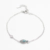 Silver bracelet with a fish-shaped charm on a white background