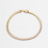 Gold bracelet with clear stones on a white background