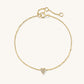 Gold bracelet with a heart-shaped charm on a white background
