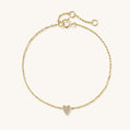 Gold bracelet with a heart-shaped charm on a white background