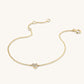 Gold bracelet with a heart-shaped clasp on a white background