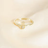 Gold ring with a diamond on a beige background