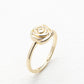 Gold rose-shaped ring on a white background