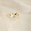 Gold spiral ring on a beige fabric background