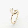 Gold ring with a unique design on a white background