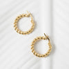 Gold hoop earrings on a white background