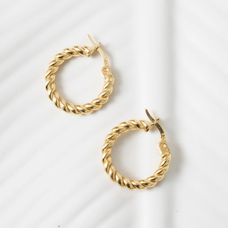Gold hoop earrings on a white background